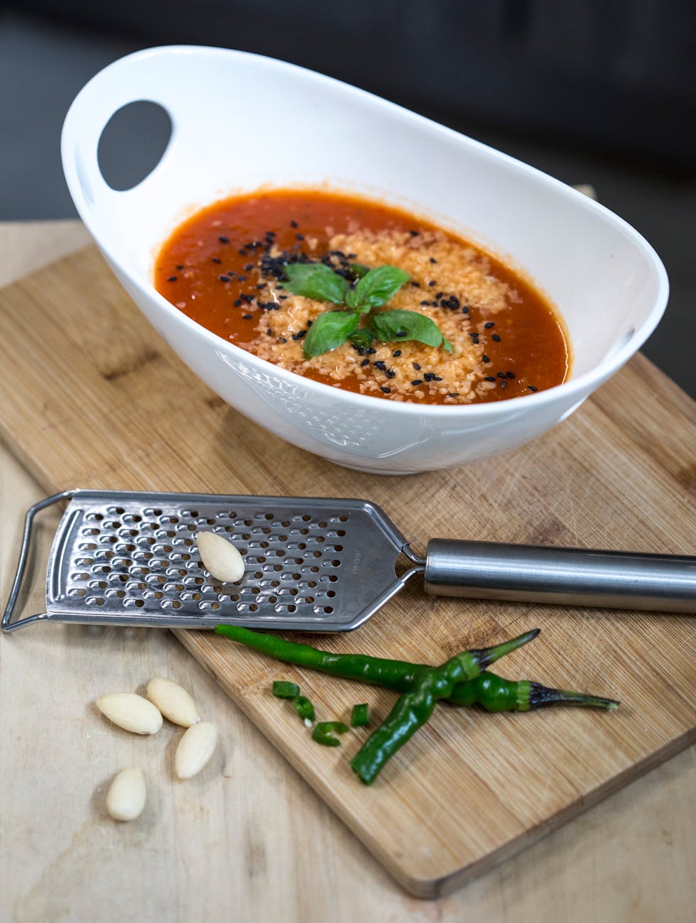 Cold gazpacho soup in a bowl with olive oil drizzle